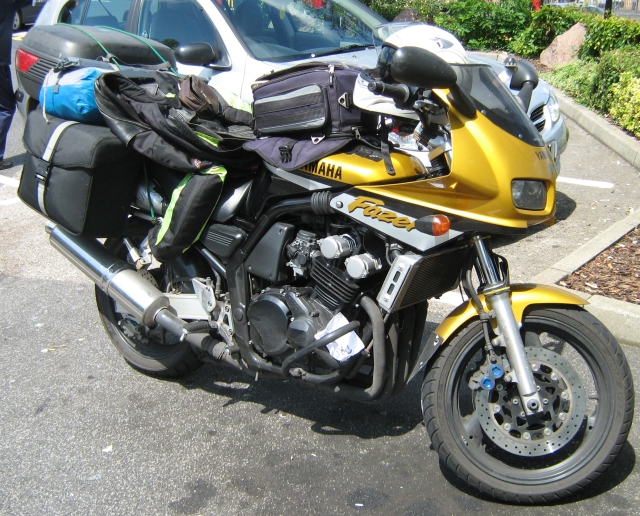 Gold and Black Yamaha Fazer 600 with camping gear, saddlebags, tent and bike jacket 